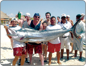 Captain Holding a marlin in Mexico after fishing in the incredible blue waters of the pacific.